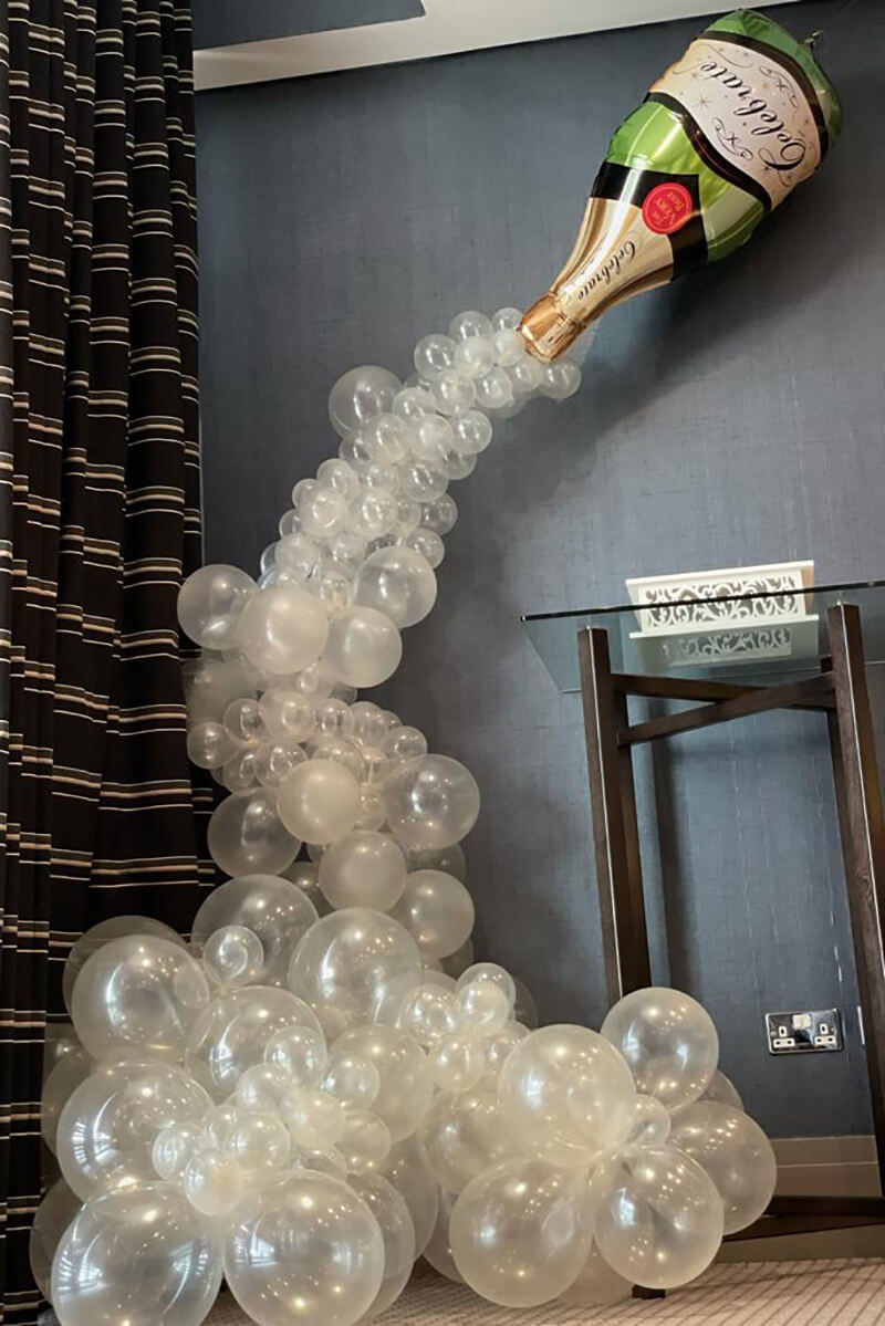 champagne bottle with balloons cascading sized compressed